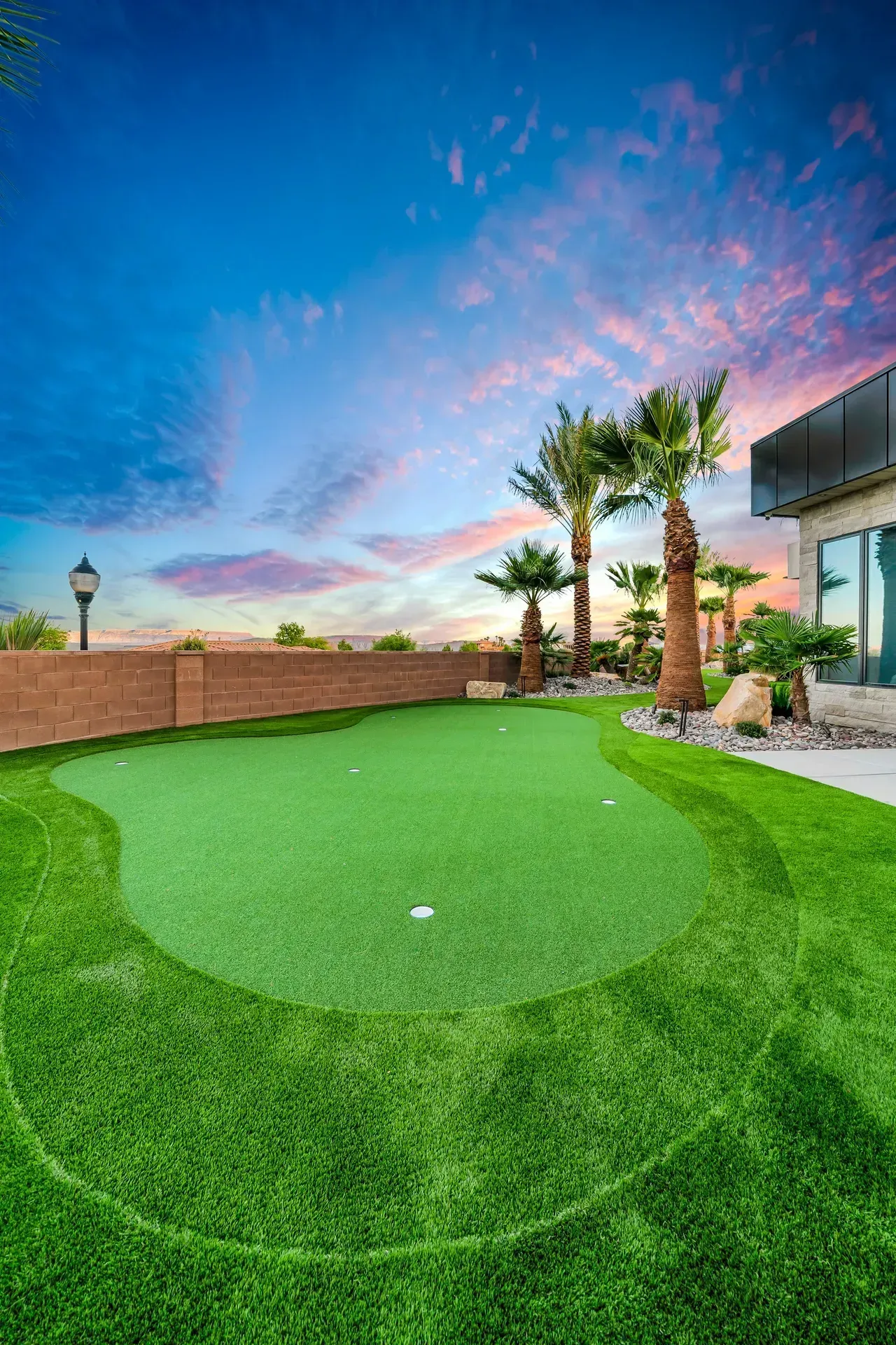 Putting green with palm trees at sunset